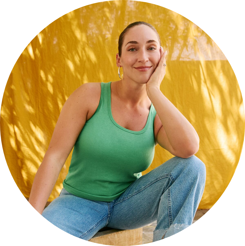 Women with closed mouth smile looking at camera